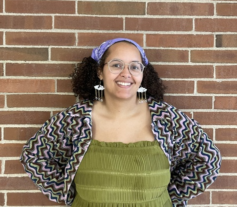 photo of Amanda smiling in front of a brick wall